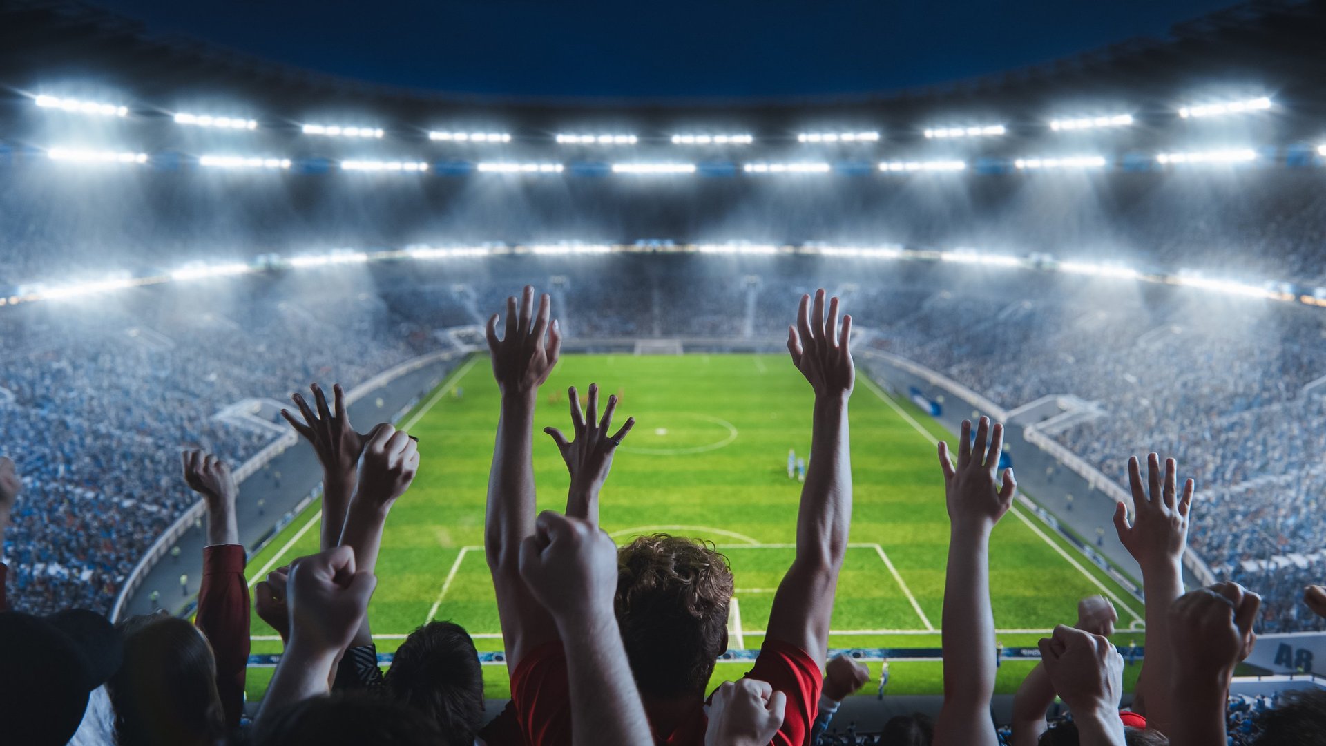 Stadion mit jubelnden Fans bei einem Fußballspiel